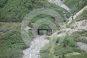 A heavy bridge over an alaskan river.