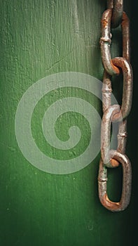 Heavy chain on brushed metal - macro with green background