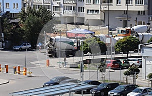 Heavy concrete trucks are waiting near a construction site in the city, trucks are making heavy air pollution