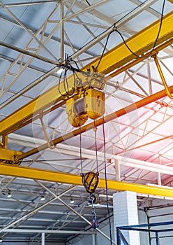 Heavy construction crane indoor. Factory transportation machinery.