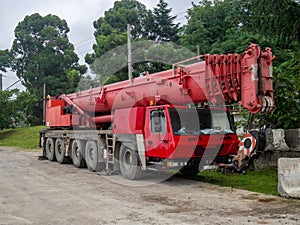 Heavy construction equipment in the parking lot. mobile crane. Red faucet. Out of work