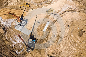 Heavy construction machinery working in construction site. aerial photo