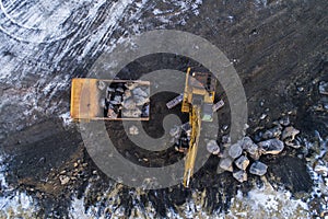 Heavy construction vehicles moving rocks on the coast in Vik, Iceland