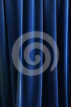 Heavy dark blue pleated textile curtain background