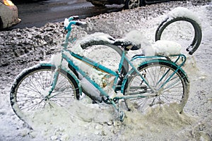 Heavy dirty snow covered parked bike