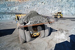 Heavy dump truck carrying the iron ore