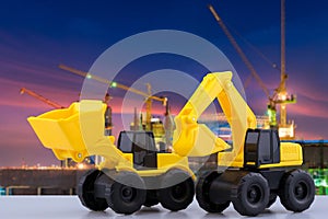 Heavy duty construction backhoe and Tractor toy with construction site in background