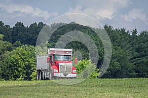 Heavy-Duty Dump Truck Enters Highway From Access Ramp in Summer