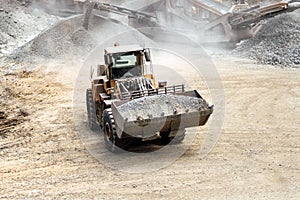 Heavy duty excavator working at quarry moving gravel