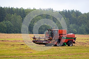 Heavy duty farm equipment in the field. Big combine harvester vehicle outside