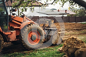heavy duty industrial bulldozer landscaping and moving earth in the garden