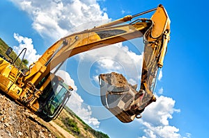 Heavy duty, industrial excavator moving earth