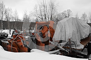 Heavy duty orange cement mixer in scrap yard