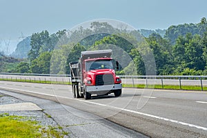 Heavy Duty Red Dump Truck On Hazy Summer Day