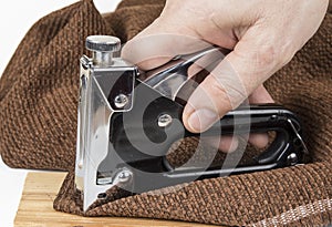 Heavy duty staple gun with staples on the white background.