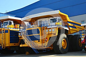 Heavy-duty truck warehouse at autoworks. Giant mining dump trucks manufacture by the heavy vehicle plant.