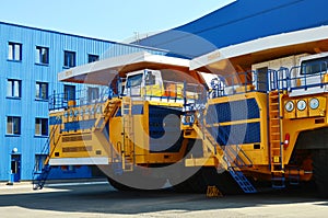 Heavy-duty trucks warehouse at autoworks. Giant mining dump truck manufacture by the heavy vehicle plant.