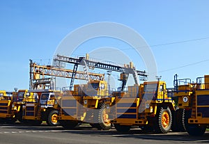 Heavy-duty trucks warehouse at autoworks. Giant mining dump trucks manufacture by the heavy vehicle plant.