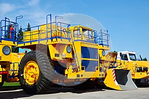 Heavy-duty trucks warehouse at autoworks. Giant mining dump trucks manufacture by the heavy vehicle plant.