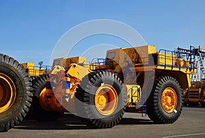 Heavy-duty trucks warehouse at autoworks. Giant mining dump trucks manufacture by the heavy vehicle plant.