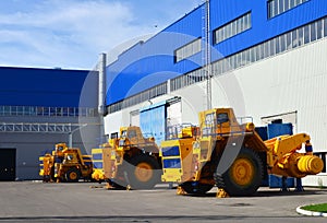 Heavy-duty trucks warehouse at autoworks. Giant mining dump trucks manufacture by the heavy vehicle plant.