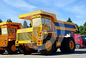 Heavy-duty trucks warehouse at autoworks. Giant mining dump trucks manufacture by the heavy vehicle plant.