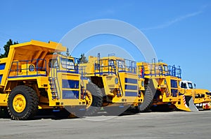 Heavy-duty trucks warehouse at autoworks. Giant mining dump trucks manufacture by the heavy vehicle plant.