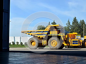 Heavy-duty trucks warehouse at autoworks. Giant mining dump trucks manufacture by the heavy vehicle plant.