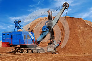 Heavy electric excavator in sandpit