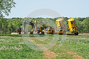 Heavy equipment truck lined up in the field