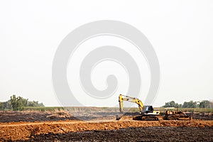 Heavy excavating equipment at construction site.