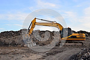 A heavy excavator in a working at granite quarry