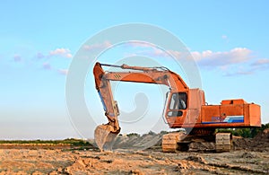 A heavy excavator in a working at granite quarry