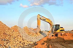 A heavy excavator in a working at granite quarry
