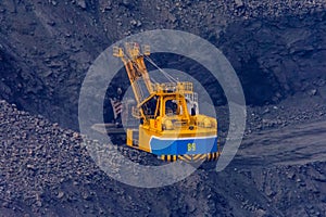 Heavy excavator working in iron ore quarry