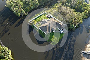 Heavy flood with high water surrounding residential house after hurricane rainfall in Florida residential area