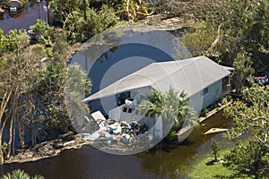 Heavy flood with high water surrounding residential house after hurricane rainfall in Florida residential area