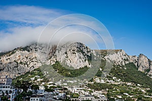 Heavy fog on Monte Solare on Capri Island in summer time with villages on the mountain