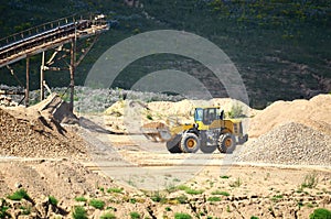 Heavy front-end loader or all-wheel bulldozer for mechanization of loading, digging and excavation operations in open quarry.