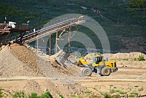 Heavy front-end loader or all-wheel bulldozer for mechanization of loading, digging and excavation operations in open quarry.