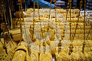 Heavy Golden ornaments kept on display at a shop in Dubai Gold Souk.  Gold Souq is biggest market of Gold Jewelry in world