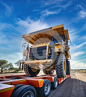 heavy haulage huge mining truck in top of a trailer photo