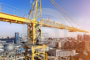 Heavy high tower crane view at skyscraper conctruction site. Industrial building background