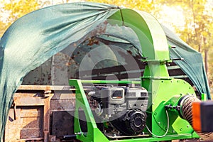 Heavy industrial vaccuum loader loading fallen leaves and junk into truck body. Municipal services cleaning park area removing