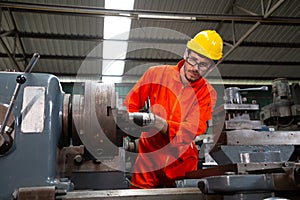Heavy industrial worker is working on metal work factory,