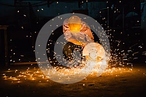 Heavy industry manual worker with grinder background