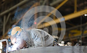 Heavy industry manual worker welding/grinding in a