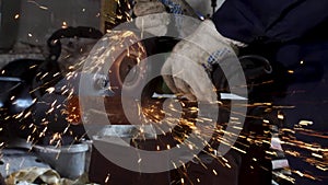Heavy industry worker cutting steel with angle grinder, high-speed video. Frame. Worker with angle grinder and