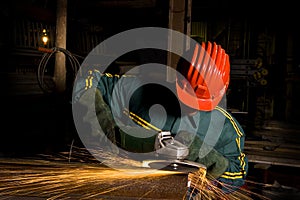 Heavy industry worker with grinder