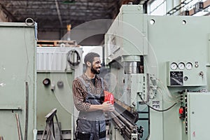 Heavy industry worker with safety headphones and hard hat in industrial factory